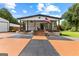 Charming single Gathering home with a spacious front porch, American flag and detached garage at 80 David Rd, Hampton, GA 30228