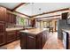 Modern kitchen featuring dark wood cabinets, stainless steel appliances, and a large island at 80 David Rd, Hampton, GA 30228
