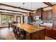 A kitchen with a large island, wooden cabinets and floors, and stainless steel appliances at 80 David Rd, Hampton, GA 30228