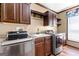A laundry room featuring stainless steel washer and dryer and wooden cabinets at 80 David Rd, Hampton, GA 30228
