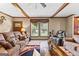 Living room with a comfortable seating arrangement, bright windows and cozy decor at 80 David Rd, Hampton, GA 30228