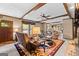 An open-concept living room with wood beams, plush sofas, and a decorative rug at 80 David Rd, Hampton, GA 30228