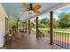 Spacious front porch with ample seating, wood floors, and scenic neighborhood views at 80 David Rd, Hampton, GA 30228