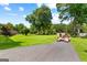 Large grassy yard with driveway and lush trees enhancing the property's curb appeal at 80 David Rd, Hampton, GA 30228