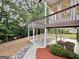 Beautiful backyard space featuring a covered patio area, columns, and a lush, landscaped lawn at 6765 Crofton Dr, Alpharetta, GA 30005