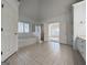 Bathroom featuring tile floors, soaking tub, shower, and double doors leading to the bedroom at 6765 Crofton Dr, Alpharetta, GA 30005