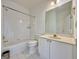 Well-lit bathroom with a vanity, toilet, and a shower with a tub at 6765 Crofton Dr, Alpharetta, GA 30005