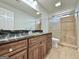 Bathroom with granite countertop vanity, wooden cabinets, and glass-enclosed shower at 6765 Crofton Dr, Alpharetta, GA 30005