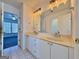 Bathroom featuring double vanity sinks and large mirror at 6765 Crofton Dr, Alpharetta, GA 30005