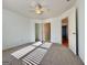 Bright bedroom with neutral carpet, fan, and three doorways at 6765 Crofton Dr, Alpharetta, GA 30005