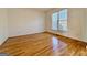 Bedroom featuring hardwood floors and a large window at 6765 Crofton Dr, Alpharetta, GA 30005