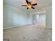 Spacious bedroom featuring carpeted floors, ceiling fan, closet, and abundant natural light at 6765 Crofton Dr, Alpharetta, GA 30005