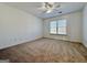 Neutral bedroom with ceiling fan, window, and carpet at 6765 Crofton Dr, Alpharetta, GA 30005