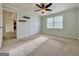 Spacious bedroom with large closet, ceiling fan, and natural light from the window at 6765 Crofton Dr, Alpharetta, GA 30005