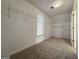 Neutral bedroom with window, carpet, closet, and wire shelving at 6765 Crofton Dr, Alpharetta, GA 30005