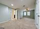 Spacious carpeted bedroom leading to an ensuite bathroom, featuring a ceiling fan and natural light at 6765 Crofton Dr, Alpharetta, GA 30005