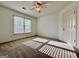 Bedroom with window, neutral carpet, and ceiling fan at 6765 Crofton Dr, Alpharetta, GA 30005