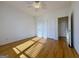 Bedroom features hardwood floors, ceiling fan, and a closet for storage at 6765 Crofton Dr, Alpharetta, GA 30005