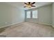 A comfortable bedroom with a ceiling fan and natural light coming through two windows at 6765 Crofton Dr, Alpharetta, GA 30005