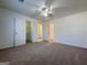Neutral bedroom with three doorways, carpet, and walk-in closet at 6765 Crofton Dr, Alpharetta, GA 30005