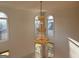 Elegant chandelier in a room with multiple windows, providing natural light and a view at 6765 Crofton Dr, Alpharetta, GA 30005