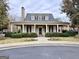 Charming community clubhouse featuring a stylish covered entrance, dormer windows, and beautifully maintained landscaping at 6765 Crofton Dr, Alpharetta, GA 30005