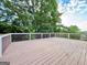 Large outdoor deck with a scenic view of the surrounding trees and sky at 6765 Crofton Dr, Alpharetta, GA 30005