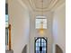 Entryway with soaring ceilings and a decorative chandelier and front door at 6765 Crofton Dr, Alpharetta, GA 30005
