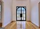 Bright foyer featuring hardwood floors and a decorative black front door at 6765 Crofton Dr, Alpharetta, GA 30005