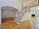 Spacious foyer featuring hardwood floors and an elegant staircase at 6765 Crofton Dr, Alpharetta, GA 30005