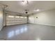 Spacious garage with high ceilings, epoxy flooring, and an automatic garage door at 6765 Crofton Dr, Alpharetta, GA 30005