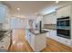 Open kitchen featuring island, stainless steel appliances, and a view to the living room at 6765 Crofton Dr, Alpharetta, GA 30005