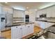 Gourmet kitchen with island, stainless appliances, and white cabinetry at 6765 Crofton Dr, Alpharetta, GA 30005