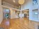 Bright living room showcasing hardwood floors, staircase, modern chandelier, and natural light at 6765 Crofton Dr, Alpharetta, GA 30005