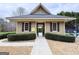 View of the community locker room with a private entrance, framed by manicured hedges and dark window shutters at 6765 Crofton Dr, Alpharetta, GA 30005