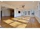 Sunlit sunroom with hardwood floors and large windows, adjacent to the kitchen at 6765 Crofton Dr, Alpharetta, GA 30005