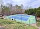 Overhead view of community tennis courts featuring a well-kept surface, surrounded by trees and green landscaping at 6765 Crofton Dr, Alpharetta, GA 30005