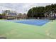 Well-maintained community tennis courts showcasing vibrant blue and green surfaces surrounded by lush greenery at 6765 Crofton Dr, Alpharetta, GA 30005