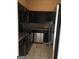 Compact kitchen featuring sleek black cabinetry, stainless steel appliances, and granite countertops at 3060 Nw Pharr Ct # 517, Atlanta, GA 30305