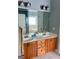 This bathroom features a double vanity, cabinets, and decorative lighting fixtures at 75 Orchard Dr, Covington, GA 30014