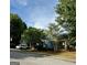 View of the side of the house, with a car parked on the driveway and mature trees in the background at 75 Orchard Dr, Covington, GA 30014