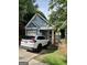View of the garage and carport, with a car parked on the driveway at 75 Orchard Dr, Covington, GA 30014