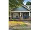 Charming home featuring a covered porch, stone accents, and a manicured lawn at 75 Orchard Dr, Covington, GA 30014