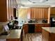 The kitchen is well-lit, with wooden cabinets, granite countertops, and modern appliances at 75 Orchard Dr, Covington, GA 30014