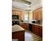 Spacious kitchen showcasing wooden cabinets, stone countertops, and stainless steel appliances at 75 Orchard Dr, Covington, GA 30014