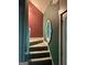 Staircase featuring a patterned window and neutral carpet at 75 Orchard Dr, Covington, GA 30014