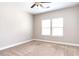 Well-lit bedroom with neutral walls and carpet at 5550 Rialto Way, Cumming, GA 30040