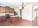 Kitchen with island, granite countertops, and hardwood floors at 5550 Rialto Way, Cumming, GA 30040