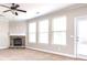 Spacious living room featuring a fireplace and large windows at 5550 Rialto Way, Cumming, GA 30040