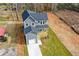 Aerial view of new construction home in wooded area. A long driveway leads to a one car garage at 192 Pecan Dr, Canton, GA 30114